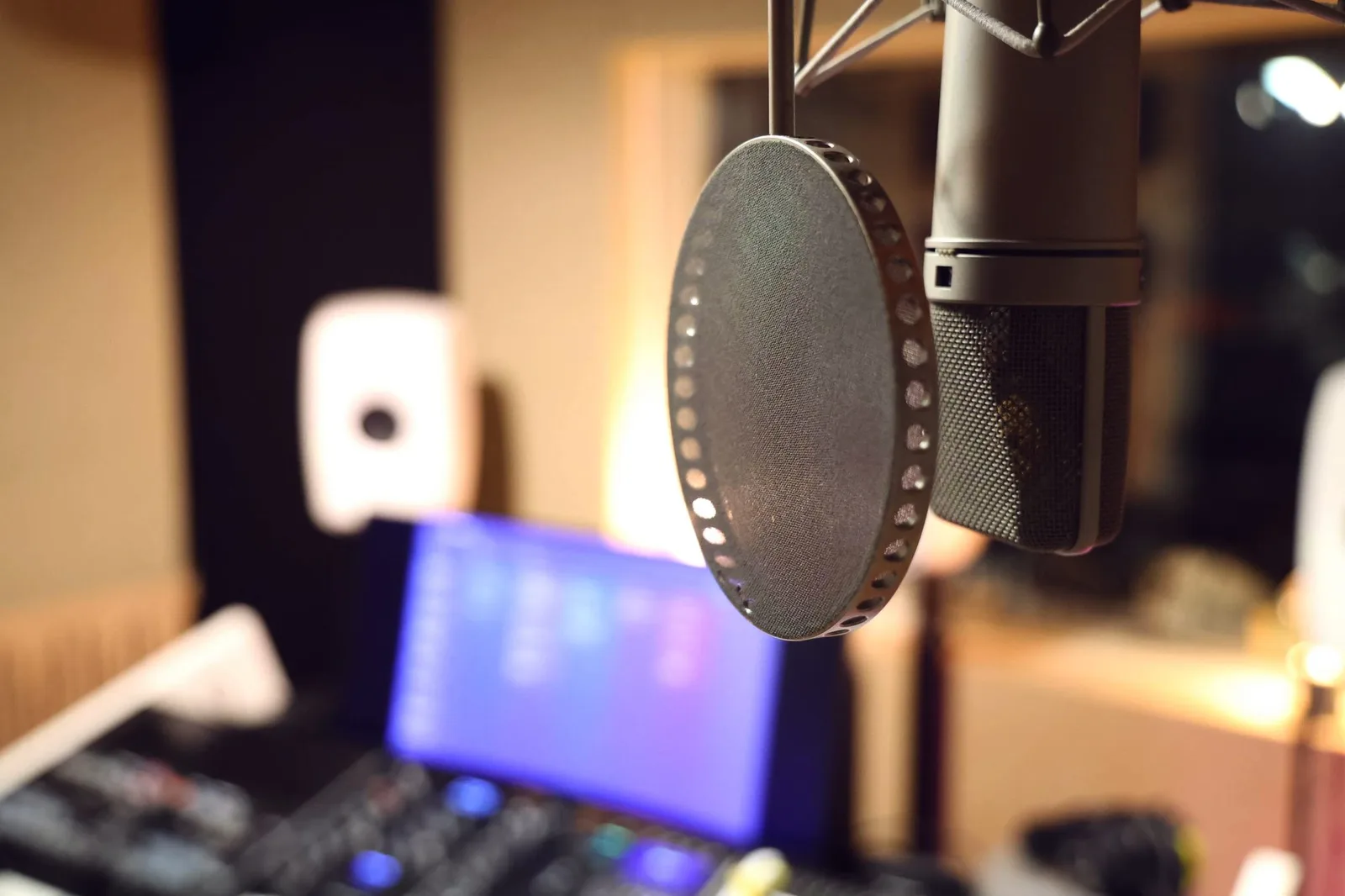 Vocal booth microphone with TrackSpace on a screen behind