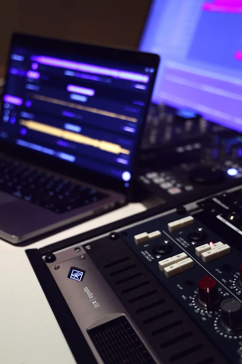Laptop running TrackSpace next to outboard mastering gear